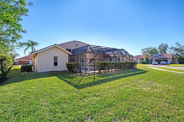 1144 Hoover St, Nokomis, FL 34275 - back of house with a yard, stucco siding, and a lanai