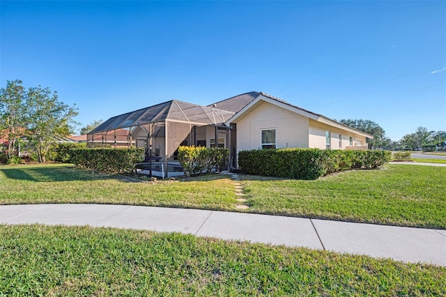 1144 Hoover St, Nokomis, FL 34275 - view of front of property featuring a front yard, a lanai, and stucco siding