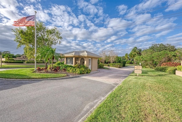 1144 Hoover St, Nokomis, FL 34275 - view of front facade featuring driveway, a front lawn, and stucco siding