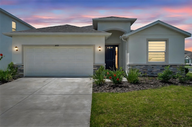 4405 Weathered Moss Gln, Palmetto, FL 34221 - ranch-style home featuring stone siding, stucco siding, a garage, and driveway