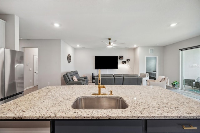 4405 Weathered Moss Gln, Palmetto, FL 34221 - kitchen featuring freestanding refrigerator, open floor plan, ceiling fan, recessed lighting, and light stone counters