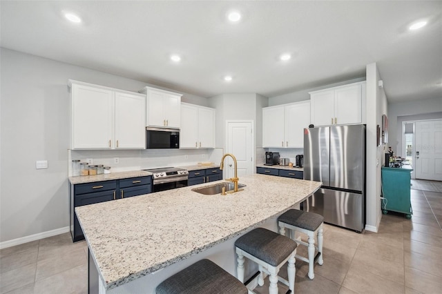 4405 Weathered Moss Gln, Palmetto, FL 34221 - kitchen featuring stainless steel appliances, white cabinetry, blue cabinetry, a kitchen breakfast bar, and recessed lighting