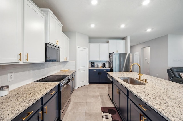 4405 Weathered Moss Gln, Palmetto, FL 34221 - kitchen with appliances with stainless steel finishes, white cabinetry, backsplash, light stone countertops, and recessed lighting
