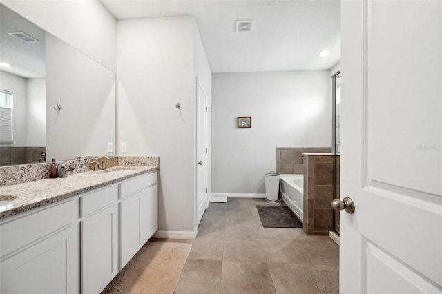 4405 Weathered Moss Gln, Palmetto, FL 34221 - bathroom with double vanity, a bath, healthy amount of natural light, tile patterned flooring, and recessed lighting
