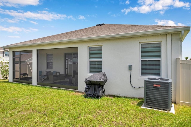 4405 Weathered Moss Gln, Palmetto, FL 34221 - back of house featuring a yard, a sunroom, a shingled roof, and stucco siding