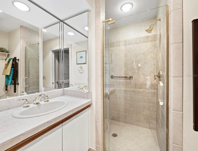 615 Dream Island Pl Unit 105, Longboat Key, FL 34228 - bathroom featuring a shower stall, vanity, and recessed lighting