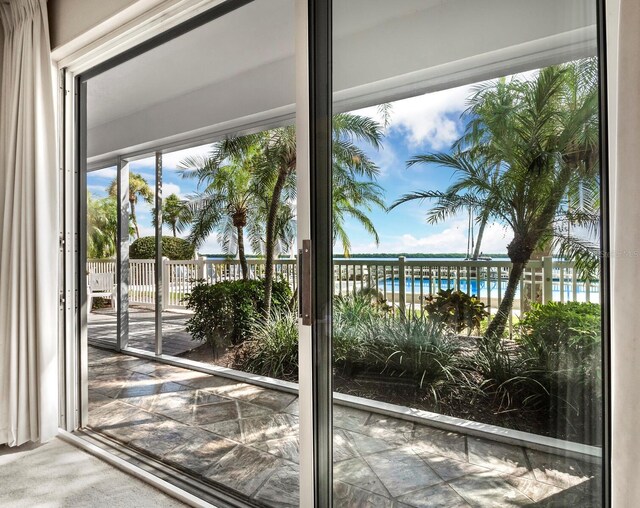 615 Dream Island Pl Unit 105, Longboat Key, FL 34228 - doorway with a water view and carpet