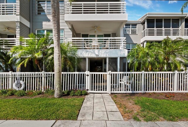 615 Dream Island Pl Unit 105, Longboat Key, FL 34228 - view of building exterior with a fenced front yard