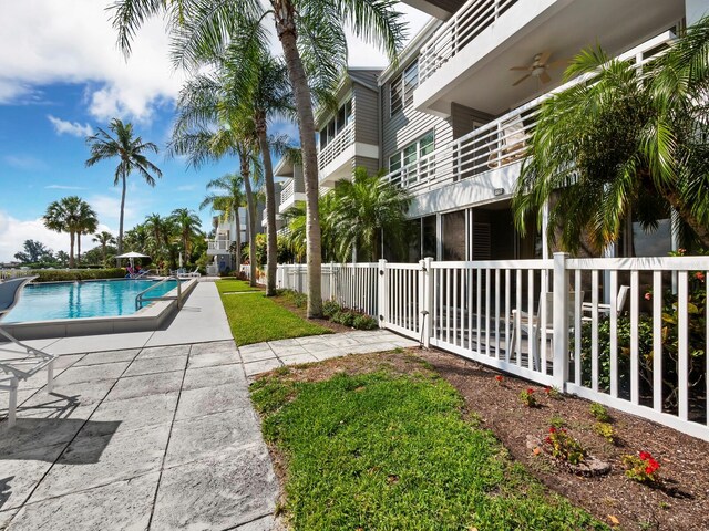 615 Dream Island Pl Unit 105, Longboat Key, FL 34228 - community pool featuring a ceiling fan and a patio