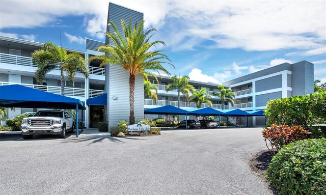615 Dream Island Pl Unit 105, Longboat Key, FL 34228 - view of building exterior with covered parking