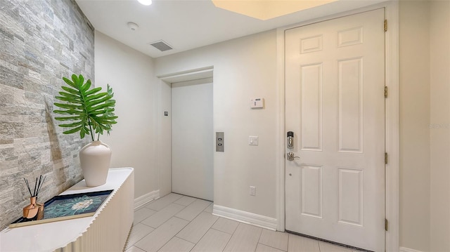 1921 Monte Carlo Dr Unit 302, Sarasota, FL 34231 - foyer entrance with elevator and baseboards