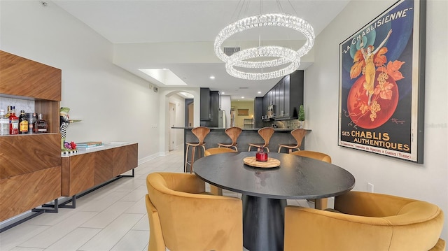 1921 Monte Carlo Dr Unit 302, Sarasota, FL 34231 - dining space featuring arched walkways, a chandelier, and light tile patterned flooring