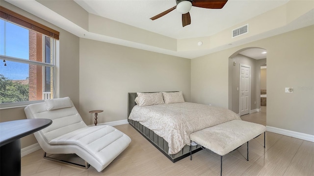 1921 Monte Carlo Dr Unit 302, Sarasota, FL 34231 - bedroom featuring arched walkways, multiple windows, light wood finished floors, and ceiling fan