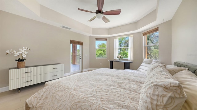 1921 Monte Carlo Dr Unit 302, Sarasota, FL 34231 - bedroom featuring access to outside, multiple windows, a ceiling fan, and a raised ceiling