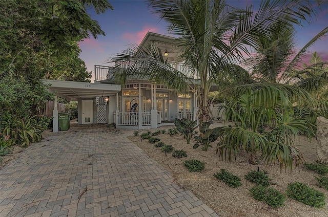 160 Coolidge Dr, Sarasota, FL 34236 - view of front facade featuring french doors, decorative driveway, and a balcony