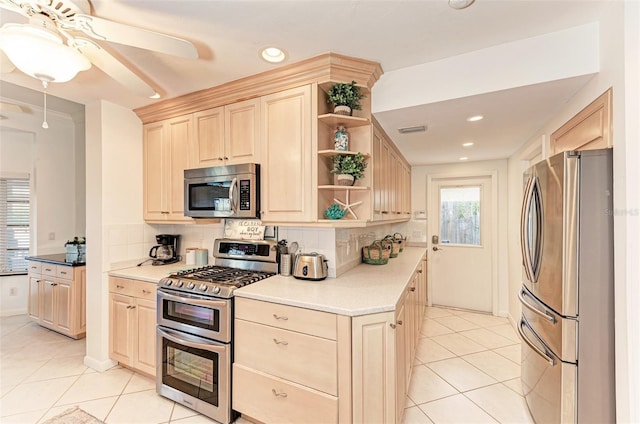 160 Coolidge Dr, Sarasota, FL 34236 - kitchen featuring appliances with stainless steel finishes, light brown cabinets, open shelves, light tile patterned flooring, and decorative backsplash