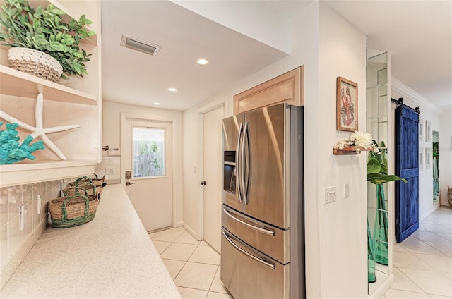 160 Coolidge Dr, Sarasota, FL 34236 - kitchen featuring stainless steel fridge with ice dispenser, light tile patterned floors, light countertops, recessed lighting, and a barn door