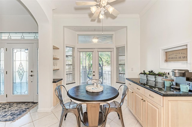 160 Coolidge Dr, Sarasota, FL 34236 - dining area with light tile patterned floors, a ceiling fan, arched walkways, french doors, and crown molding