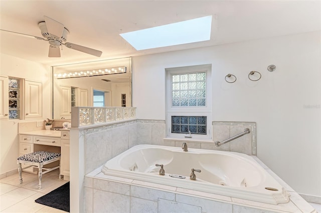 160 Coolidge Dr, Sarasota, FL 34236 - full bathroom featuring a skylight, a tub with jets, vanity, tile patterned floors, and ceiling fan