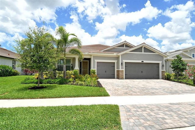 8668 Sundance Loop, Sarasota, FL 34238 - view of front facade featuring an attached garage, a front yard, and decorative driveway