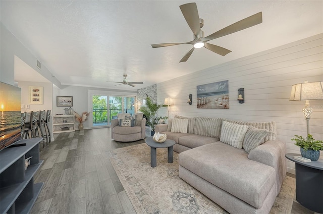 1740 Alderman St Unit 7, Sarasota, FL 34236 - living area with a ceiling fan, wood finished floors, and wooden walls