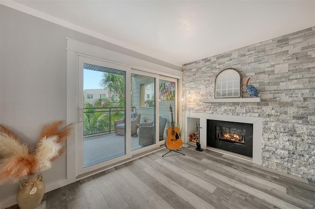 1740 Alderman St Unit 7, Sarasota, FL 34236 - unfurnished living room with a lit fireplace and wood finished floors