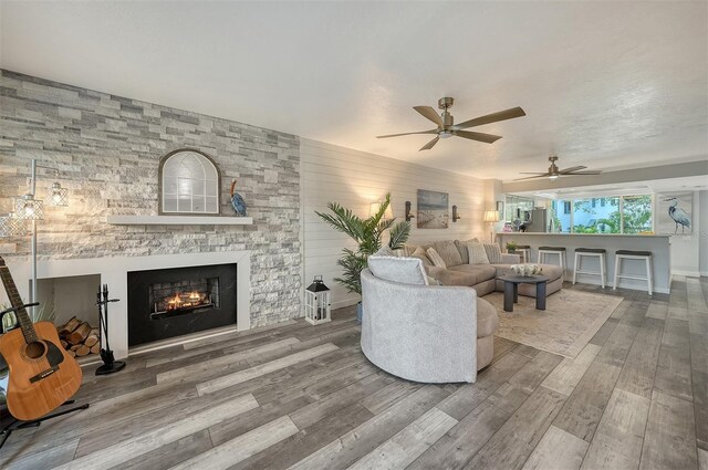 1740 Alderman St Unit 7, Sarasota, FL 34236 - living area with wood finished floors, ceiling fan, and a stone fireplace