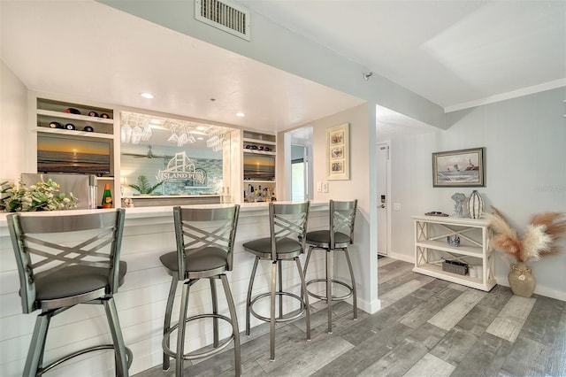 1740 Alderman St Unit 7, Sarasota, FL 34236 - kitchen featuring wood finished floors, built in features, a breakfast bar area, and recessed lighting