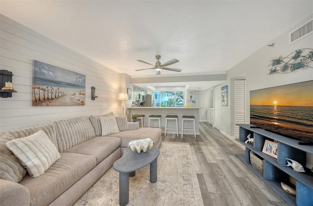 1740 Alderman St Unit 7, Sarasota, FL 34236 - living area with light wood-style flooring, wooden walls, and a ceiling fan