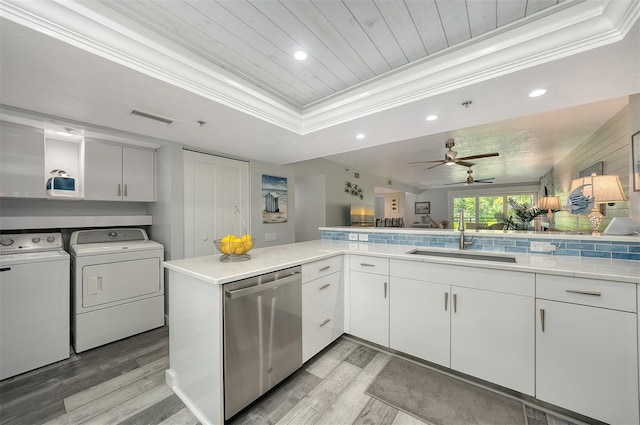 1740 Alderman St Unit 7, Sarasota, FL 34236 - kitchen with dishwasher, washer and clothes dryer, a tray ceiling, light wood-type flooring, and crown molding