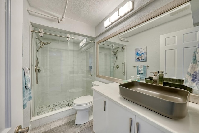 1740 Alderman St Unit 7, Sarasota, FL 34236 - bathroom with a textured ceiling, a shower stall, vanity, and wood finished floors