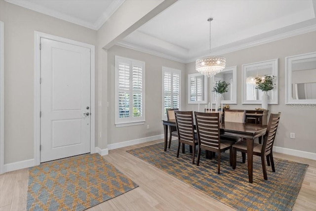 3344 Anchor Bay Trl, Bradenton, FL 34211 - dining room with a chandelier, wood finished floors, ornamental molding, and a raised ceiling