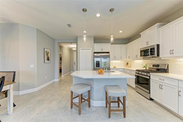 11685 Great Brook Ln, Parrish, FL 34219 - kitchen featuring appliances with stainless steel finishes, tasteful backsplash, light countertops, white cabinets, and recessed lighting
