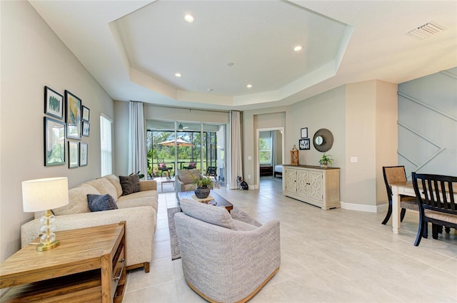 11685 Great Brook Ln, Parrish, FL 34219 - living area with a tray ceiling, recessed lighting, and light tile patterned flooring