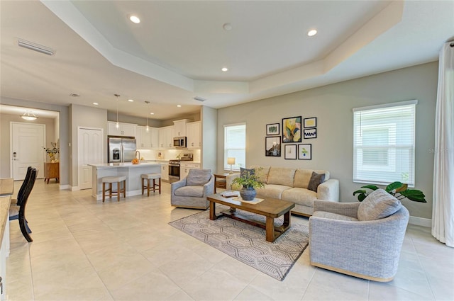 11685 Great Brook Ln, Parrish, FL 34219 - living room with a raised ceiling, recessed lighting, and light tile patterned flooring