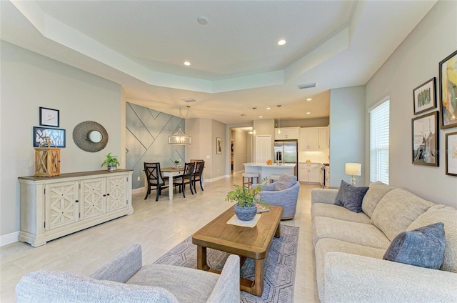 11685 Great Brook Ln, Parrish, FL 34219 - living area with a raised ceiling, recessed lighting, and light tile patterned floors