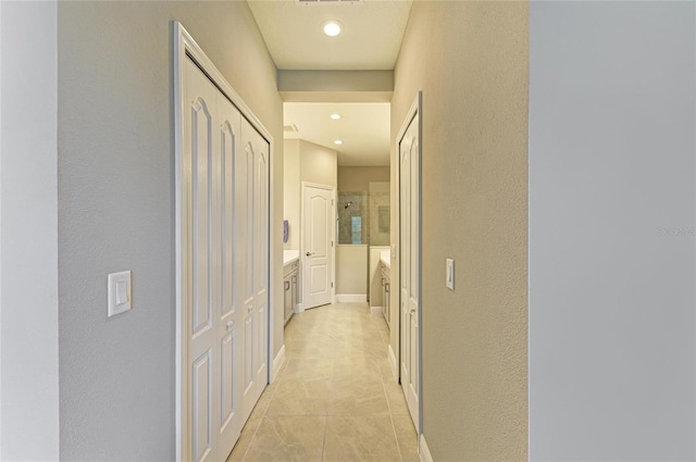 11685 Great Brook Ln, Parrish, FL 34219 - corridor with light tile patterned floors, a textured wall, and recessed lighting