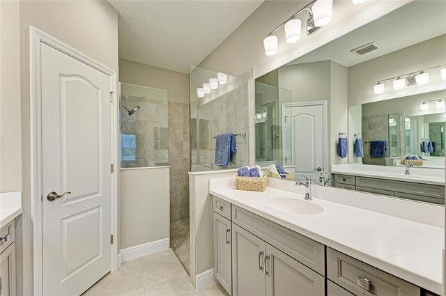 11685 Great Brook Ln, Parrish, FL 34219 - bathroom featuring walk in shower, two vanities, and tile patterned flooring