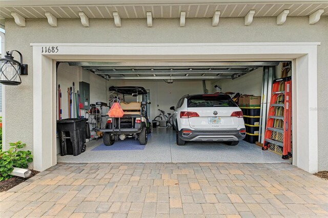 11685 Great Brook Ln, Parrish, FL 34219 - garage with decorative driveway and electric panel