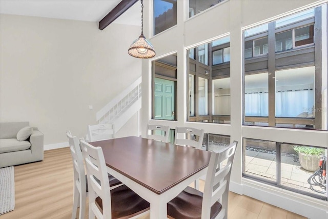 800 S Blvd Of The Presidents Unit 16, Sarasota, FL 34236 - dining area featuring light wood-style flooring, stairway, beam ceiling, and plenty of natural light