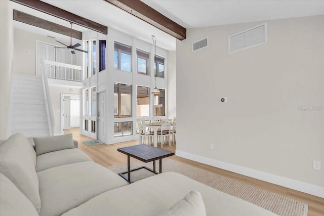 800 S Blvd Of The Presidents Unit 16, Sarasota, FL 34236 - living area with wood finished floors, beamed ceiling, ceiling fan, stairs, and high vaulted ceiling