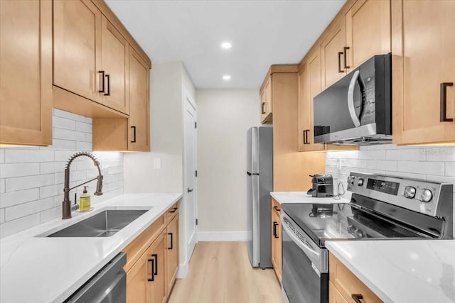 800 S Blvd Of The Presidents Unit 16, Sarasota, FL 34236 - kitchen featuring stainless steel appliances, light wood-style floors, decorative backsplash, light stone counters, and recessed lighting