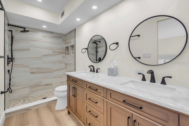 800 S Blvd Of The Presidents Unit 16, Sarasota, FL 34236 - bathroom featuring double vanity, recessed lighting, and a tile shower