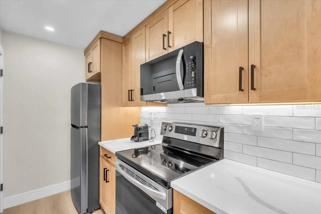 800 S Blvd Of The Presidents Unit 16, Sarasota, FL 34236 - kitchen featuring stainless steel appliances, decorative backsplash, light wood-style floors, light brown cabinetry, and recessed lighting