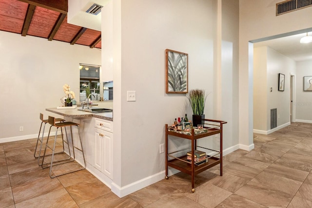4232 Pandora Rd, Venice, FL 34293 - corridor with a sink and a wood ceiling with exposed beams