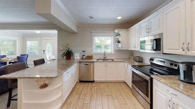 152 Coolidge Dr, Sarasota, FL 34236 - kitchen featuring stainless steel appliances, open shelves, white cabinets, and crown molding