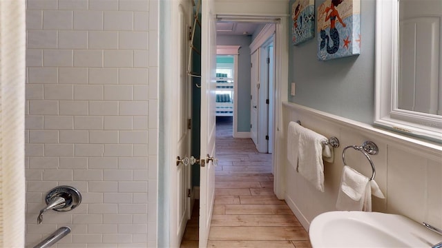 152 Coolidge Dr, Sarasota, FL 34236 - bathroom with wood finished floors and a wainscoted wall