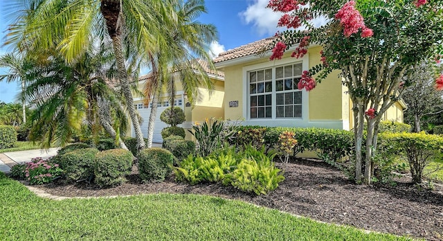 8183 Nice Way, Sarasota, FL 34238 - view of side of home featuring stucco siding and a tiled roof