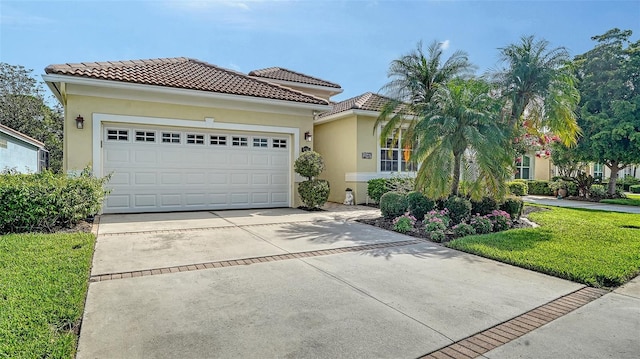 8183 Nice Way, Sarasota, FL 34238 - mediterranean / spanish house featuring driveway, a tile roof, stucco siding, and a garage