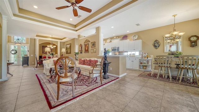 8183 Nice Way, Sarasota, FL 34238 - living area featuring a chandelier, ceiling fan, light tile patterned floors, a tray ceiling, and crown molding